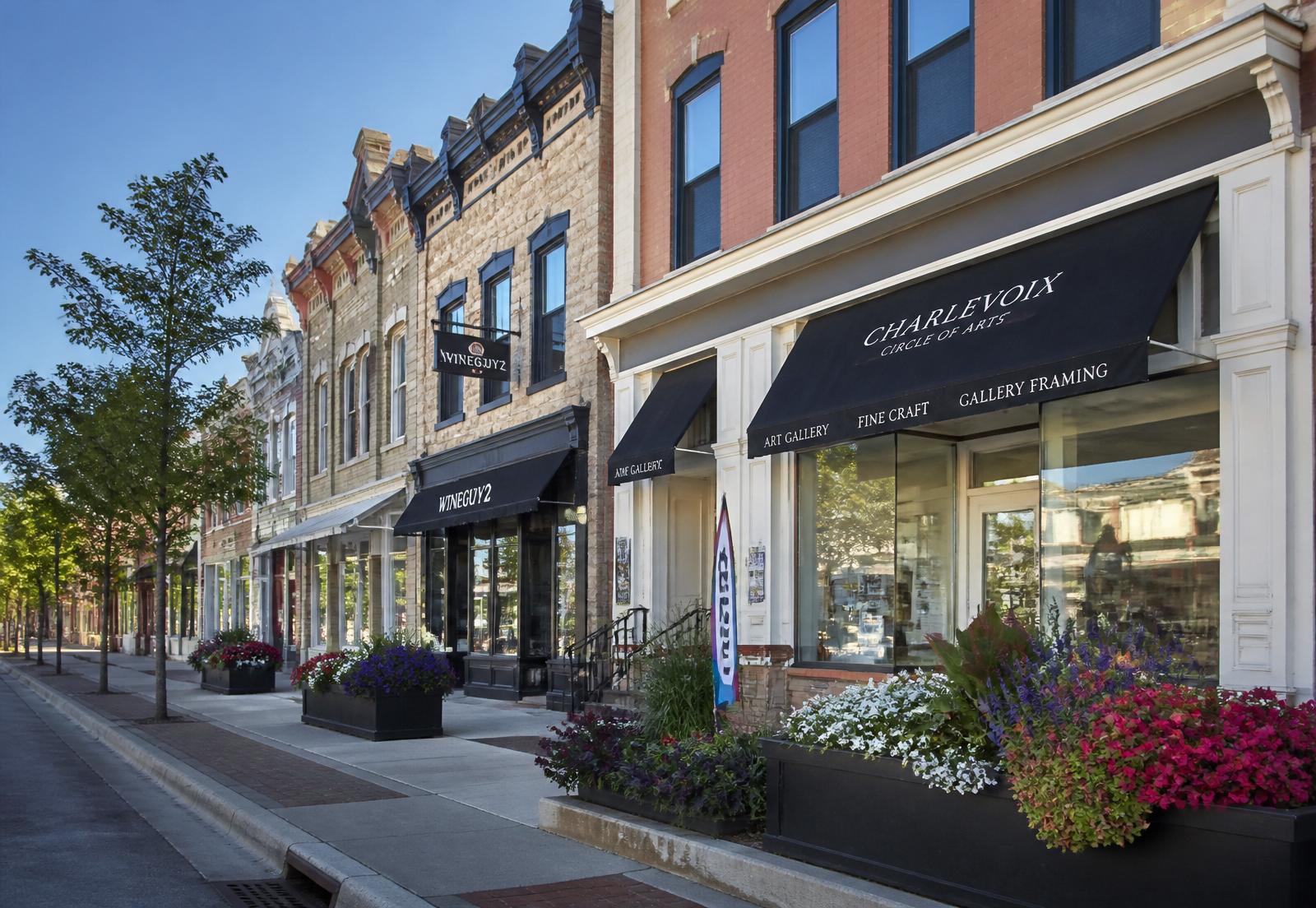 Historic brick and limestone storefronts along Bridge Street in downtown Charlevoix, Michigan